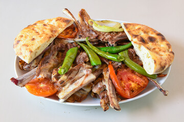 Famous Urfa meat liver, ciger wrapped by lavash with roasted chili pepper, onion and sauce in...
