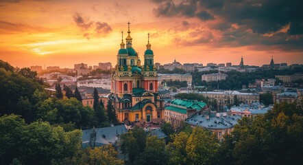 Fototapeta premium Stunning Orange Sunset Over Kiev: A Beautiful Cityscape with Clouds and Modern Architecture