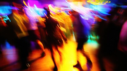 Abstract motion blur of people dancing in a nightclub with vibrant colorful lights.