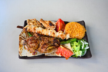 Famous Urfa meat liver, ciger wrapped by lavash with roasted chili pepper, onion and sauce in Sanliurfa, Turkey. Kuzu et ciger sis. Izgara dana bonfile, cop sis, kuzu pirzola. Karisik kebap, beyti keb