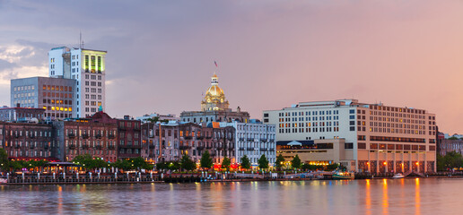 Panorama of illuminated waterfront Historic District at dusk, Savannah downtown, USA