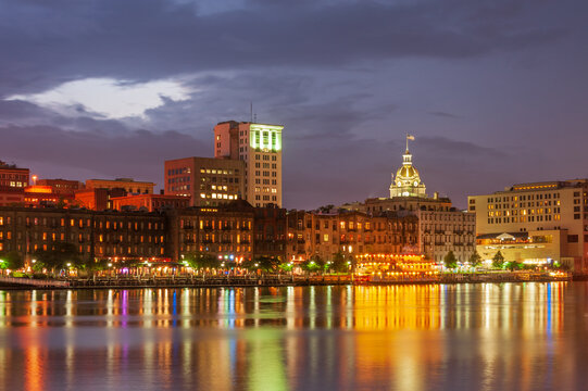 Panorama of illuminated waterfront Historic District at dusk, Savannah downtown, USA