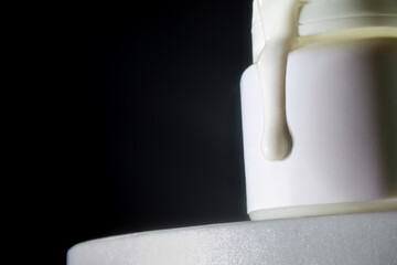 White liquid dripping from bottle