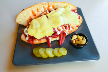 Close-up shot of Izmir's famous Turkish Traditional Kumru Sandwich, Ceşme Kumru, patso ingredients ready to eat salami, soudjouk, tomato, cheddar cheese and fried cheese. Yengen sandvic.