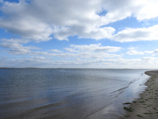 Natural reflections upon the still waters of Chatham Lighthouse Beach, Cape Cod, Massachusetts, during the winter season. 
