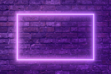 Glowing neon frame on grunge purple brick wall. Purple neon light on brick wall close-up.