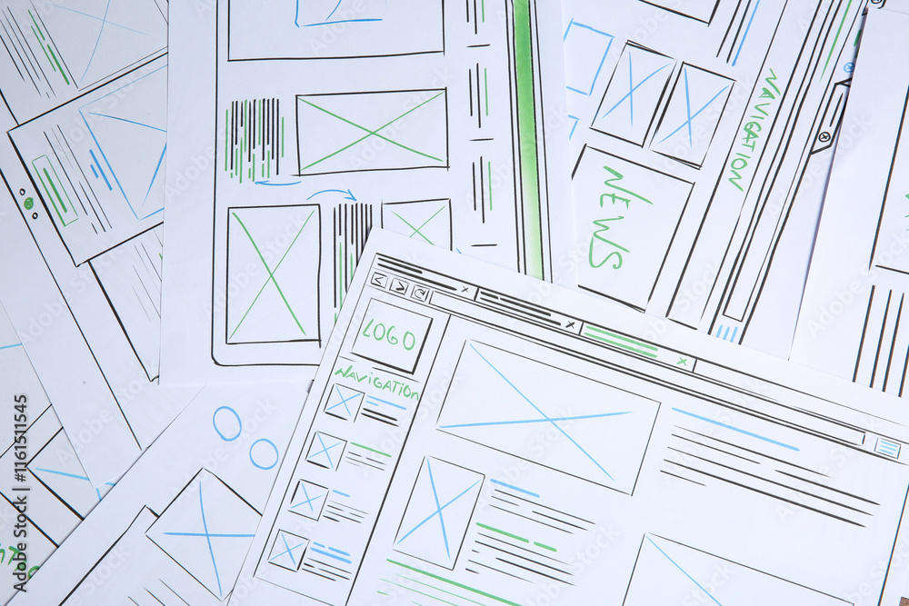 Wall mural developing ui design. sketches of website wireframes as background, top view