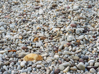 Beach covered with pebble. Nature material. Random size and shape. Abstract background.