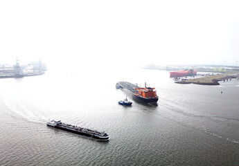 A large oil tanker and tugs in the port of Rotterdam
