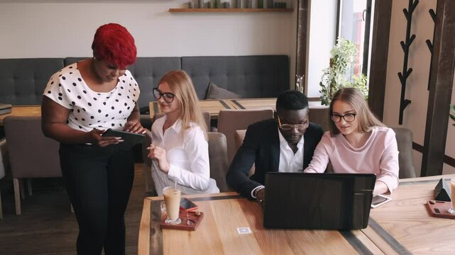 a group is working togeather on a project debating and sharing ideas