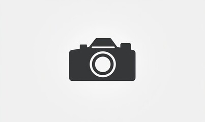 Simple grey camera icon illustration.