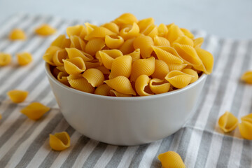 Dry Organic Medium Pasta Shells in a Bowl, side view.