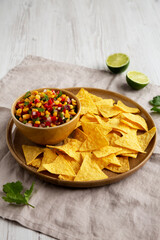 Homemade Corn Salsa with Tortilla Chips on a Plate, low angle view.