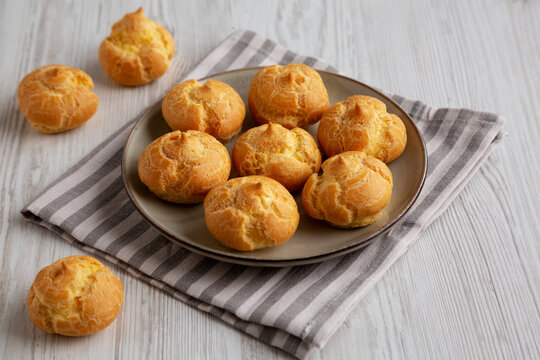 Homemade French Mini Cream Puffs on a Plate, side view.