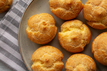 Homemade French Mini Cream Puffs on a Plate, top view.