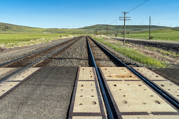 Two sets of railroad tracks at a crossing in Telocaset, Oregon, USA