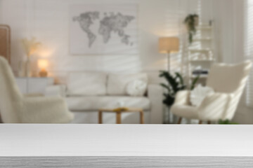 Empty white wooden table in beautiful living room. Space for design