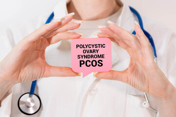 PCOS Polycystic ovary syndrome written in spiral notebook on doctor desk.