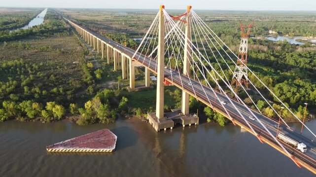 View from a drone at sunset of the pillars of the Zarate Brazo Largo complex bridge in the direction of Talavera Island