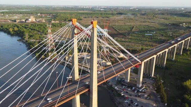 Detail of the pillars with steel cables of the Zarate bridge and heavy traffic of trucks and cars