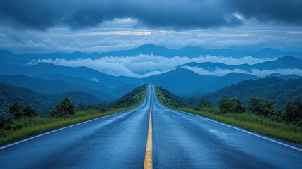 Serene Landscape with Endless Road Leading into Misty Mountains Under Dramatic Cloudy Sky, Capturing Tranquility and Beauty of Nature's Wilderness