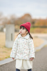 A 3-year-old Japanese girl is walking on a cold winter night in a seaside park in Hakata, Fukuoka Prefecture.