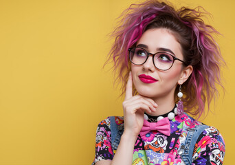 Model looking up and wondering expression, thinking of a plan with her hand below her chin, vibrant geek chic nerdy outfit aesthetic - isolated background, advertising campaign person portrait.
