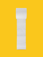 Toilet paper roll on yellow background