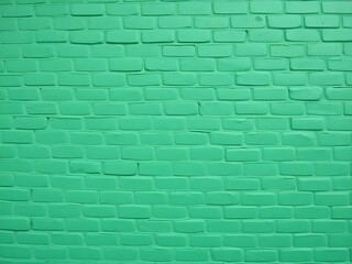 A solid wall constructed entirely of green bricks is featured in this image.