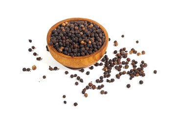 Black peppercorns (black pepper) in a wooden bowl isolated on a white background