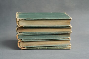 Green book stack on gray backdrop