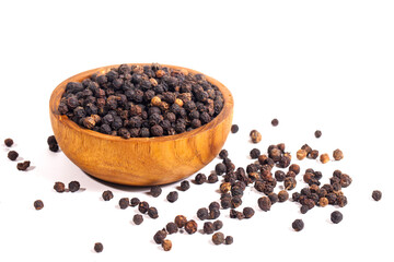 Black peppercorns (black pepper) in a wooden bowl isolated on a white background