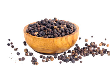 Black peppercorns (black pepper) in a wooden bowl isolated on a white background