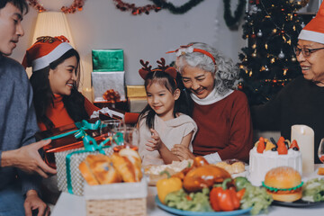 Happy family with gifts celebrating Christmas together