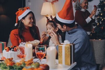Happy family with gifts celebrating Christmas together