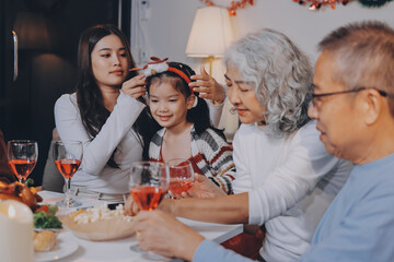Merry Christmas! Happy family are having dinner at home. Celebration holiday and togetherness near tree.
