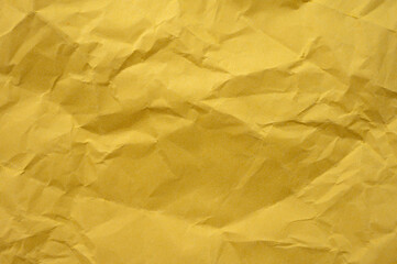 Full frame shot of crumpled yellow  paper sheet texture and background.