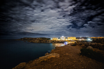 City lights in the night over mediterranean sea