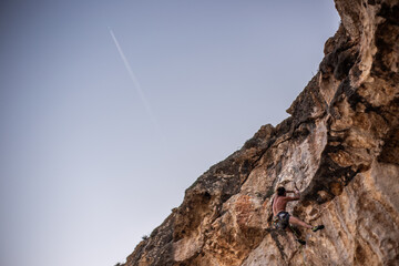 climber on a rock in mediterranean sea