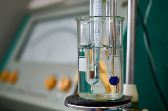 Laboratory setup with beaker containing liquid and measuring instruments in a research facility during the day