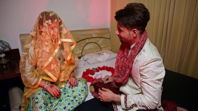 Newlyweds admiring each other on honeymoon night