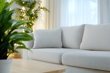 Fototapeta premium Cozy living room with a light sofa and decorative plant.