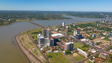 Aerial view of Encarnación, Paraguay, showcasing the city's layout and its scenic surroundings, captured from a drone perspective.