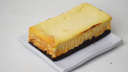 Homemade burnt cheesecake brownies isolated on white background