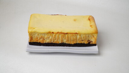 Homemade burnt cheesecake brownies isolated on white background