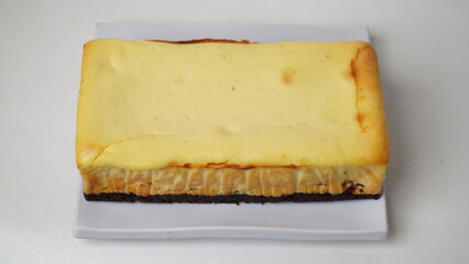 Homemade burnt cheesecake brownies isolated on white background