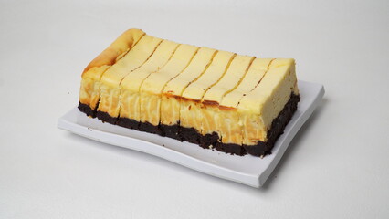 Homemade burnt cheesecake brownies isolated on white background
