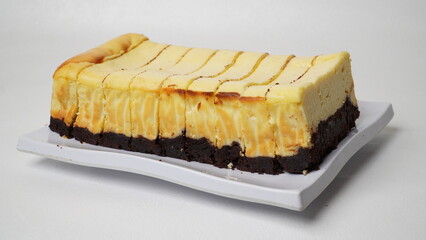 Homemade burnt cheesecake brownies isolated on white background