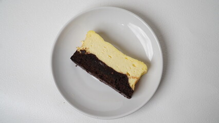Homemade burnt cheesecake brownies isolated on white background