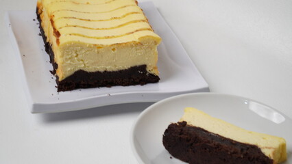 Homemade burnt cheesecake brownies isolated on white background